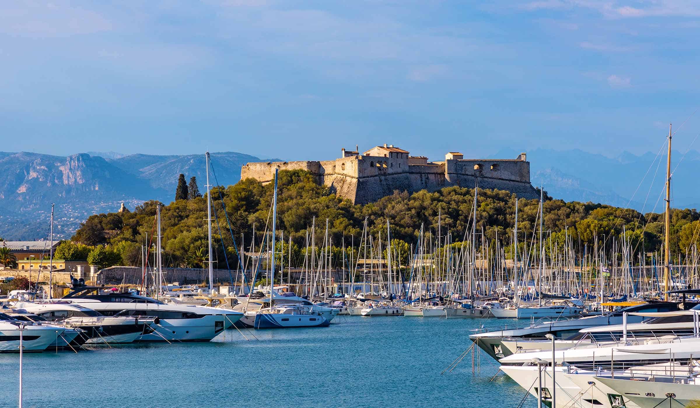 Antibes, France – August 4, 2022: Panoramic view of harbor, port and yacht marina and Fort Carre castle offshore Azure Cost of Mediterranean Sea in Antibes resort town